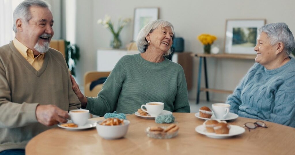 Tea, old people or friends in retirement talking for support, care or trust for bonding together in